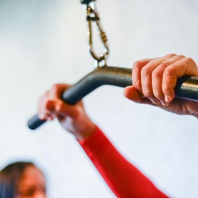 Close-up on hands gripping a pull-up bar.